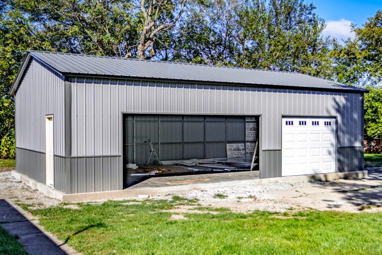 Gray Northedge Steel metal garage with white garage doors and side entrance