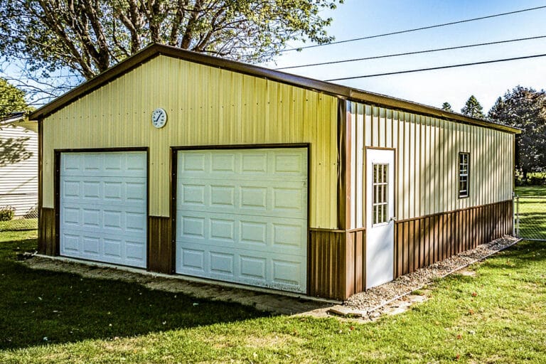 Two-tone tan and brown metal garage with white double doors and clock above